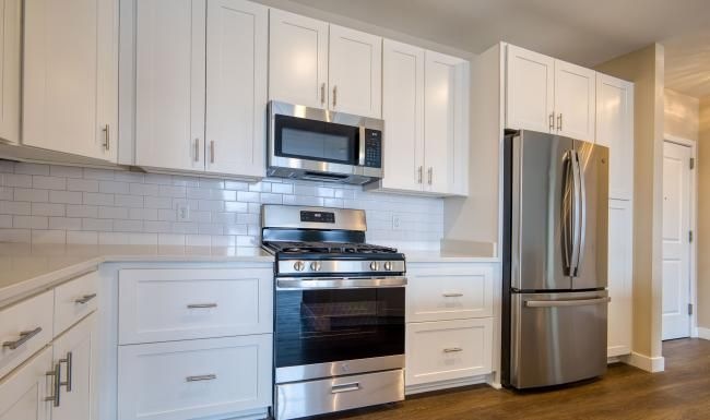 a kitchen with white cabinets