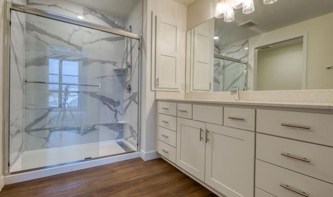 a bathroom with white cabinets