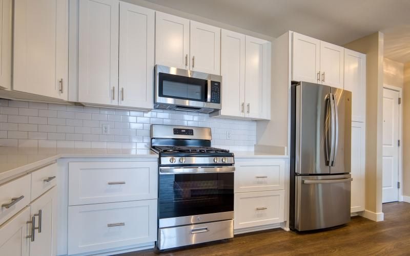 a kitchen with white cabinets